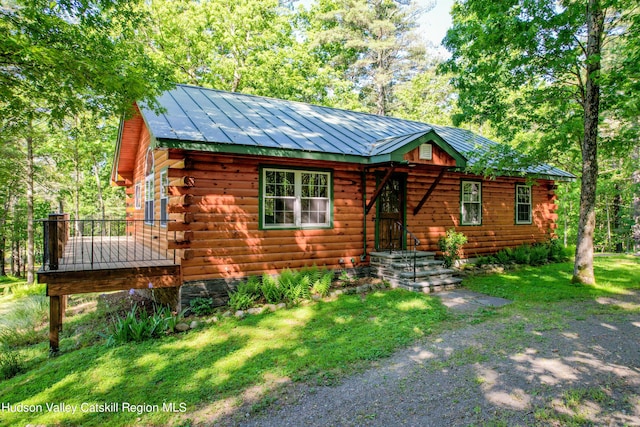 log-style house with a front yard