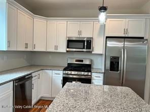 kitchen featuring light stone countertops, white cabinets, and appliances with stainless steel finishes