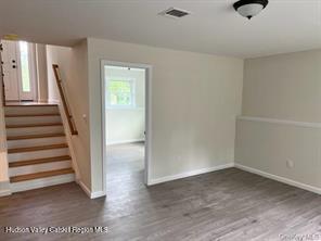 empty room with dark wood-type flooring