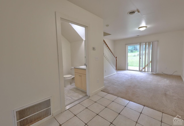15023 Rte 23 Unit 5, Prattsville, NY 12468 - unfurnished living room with stairway, light colored carpet, light tile patterned flooring, and baseboards