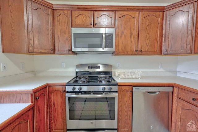 15023 Rte 23 Unit 5, Prattsville, NY 12468 - kitchen featuring appliances with stainless steel finishes, light countertops, and brown cabinetry