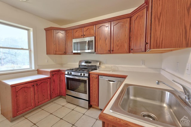 15023 Rte 23 Unit 5, Prattsville, NY 12468 - kitchen featuring appliances with stainless steel finishes, a sink, light countertops, light tile patterned flooring, and brown cabinetry