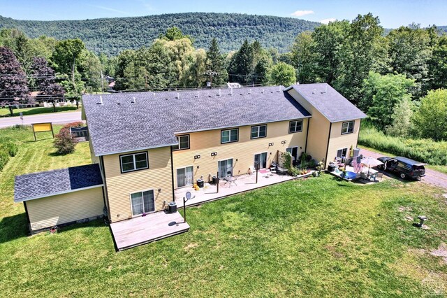 15023 Rte 23 Unit 5, Prattsville, NY 12468 - back of house with a patio area, a view of trees, central AC unit, and a lawn