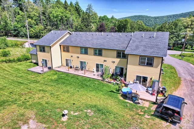 15023 Rte 23 Unit 5, Prattsville, NY 12468 - rear view of property with a wooden deck, roof with shingles, a lawn, and a forest view