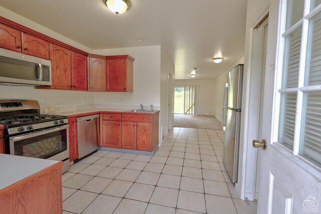 15023 Rte 23 Unit 5, Prattsville, NY 12468 - kitchen with stainless steel appliances, a sink, light countertops, light tile patterned floors, and brown cabinetry