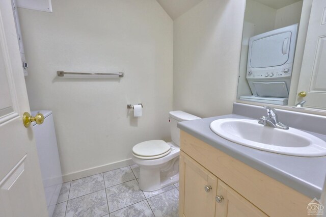 15023 Rte 23 Unit 5, Prattsville, NY 12468 - half bath with stacked washer / dryer, toilet, vanity, baseboards, and tile patterned flooring
