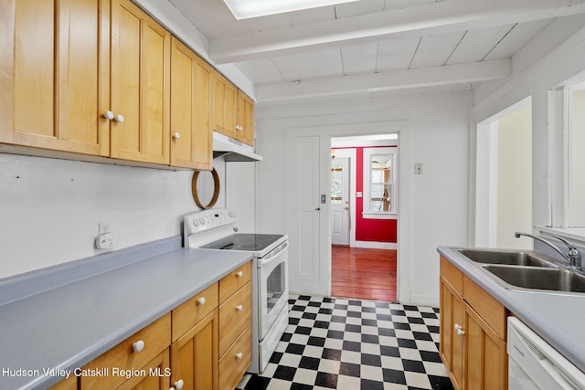 kitchen with tile patterned floors, white appliances, under cabinet range hood, beam ceiling, and a sink