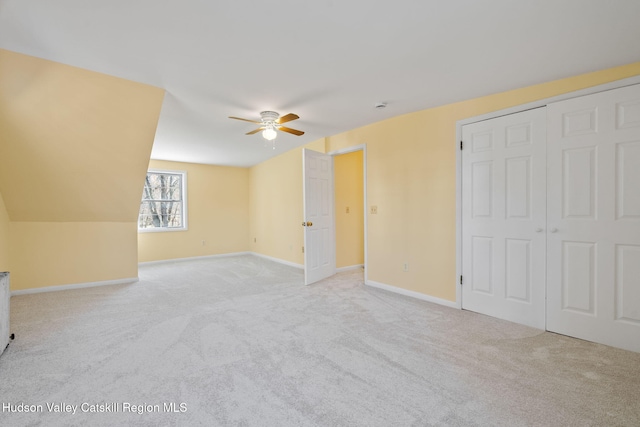 additional living space with baseboards, a ceiling fan, and carpet floors