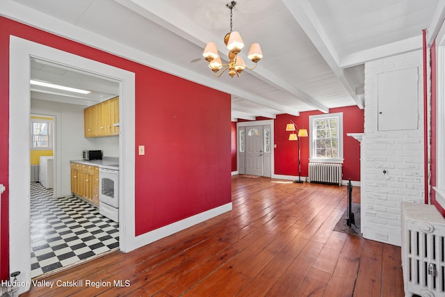 interior space featuring a notable chandelier, electric range, beamed ceiling, radiator, and wood-type flooring