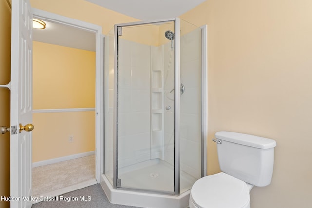 bathroom with toilet and a shower stall