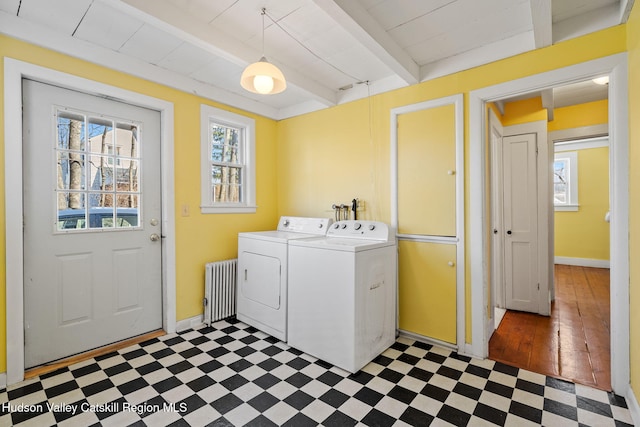 clothes washing area with tile patterned floors, radiator, laundry area, and washing machine and dryer