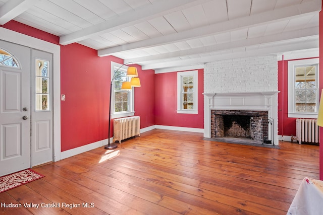 entryway featuring radiator heating unit, beamed ceiling, and hardwood / wood-style flooring