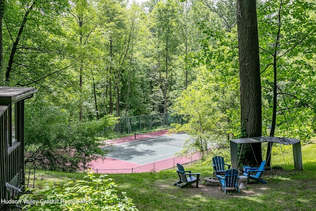 87 Boice Mill Rd, Kerhonkson, NY 12446 - view of tennis court with a wooded view and an outdoor fire pit