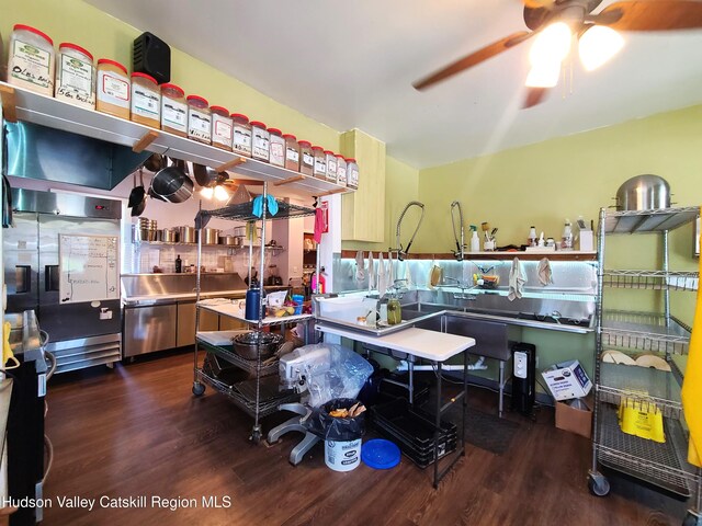 kitchen with stainless steel countertops, wood finished floors, and ceiling fan
