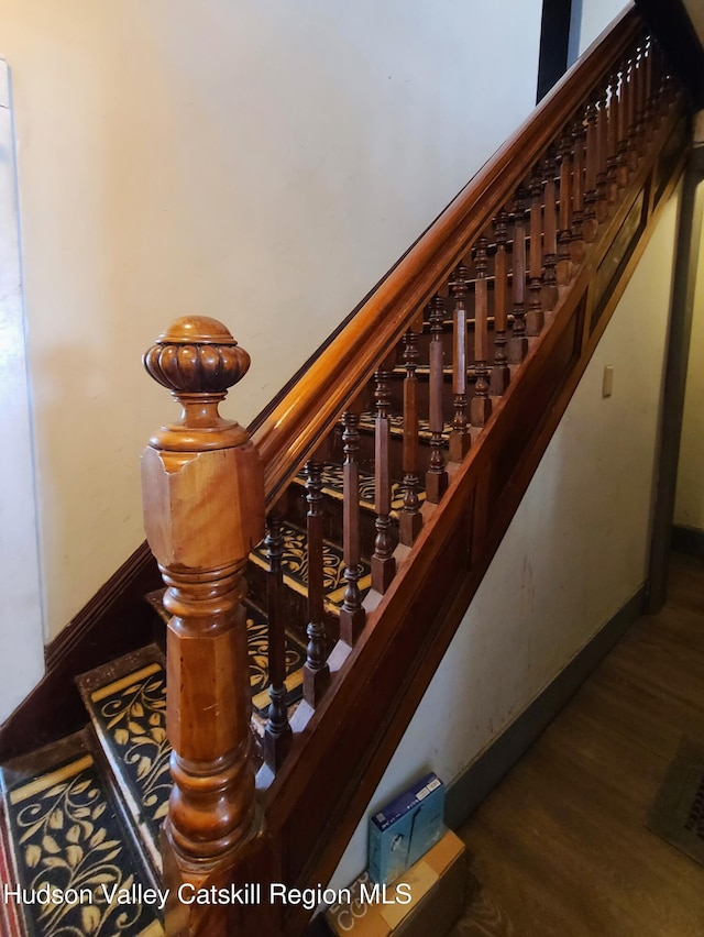 stairs featuring baseboards and wood finished floors