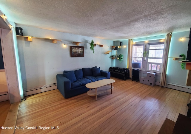 living area with a baseboard radiator, a textured ceiling, and hardwood / wood-style flooring