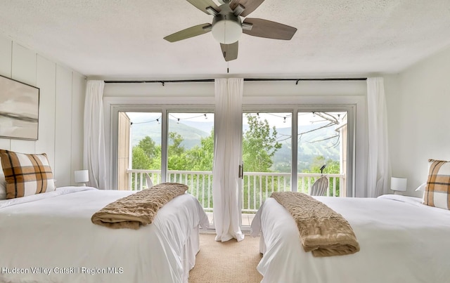 61 Scribner Hollow Rd Unit B 1, Hunter, NY 12442 - bedroom featuring access to outside, multiple windows, light colored carpet, a textured ceiling, and a ceiling fan