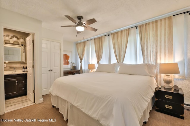 61 Scribner Hollow Rd Unit B 1, Hunter, NY 12442 - bedroom featuring light carpet, ensuite bath, a closet, and a ceiling fan