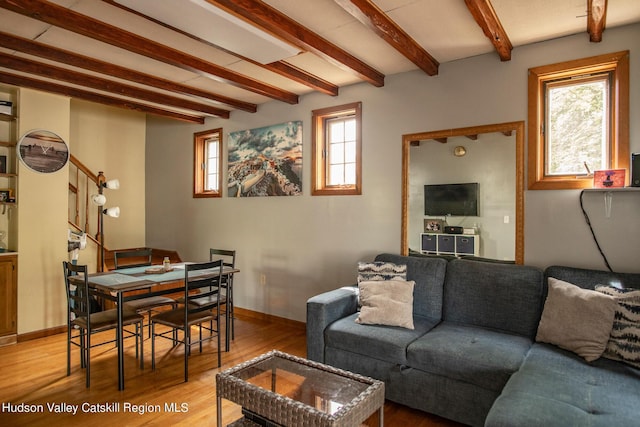 living room featuring hardwood / wood-style flooring and beamed ceiling