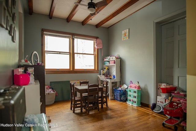 recreation room featuring wood-type flooring, ceiling fan, and beam ceiling