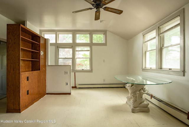 unfurnished dining area featuring a baseboard heating unit and lofted ceiling