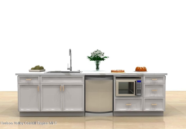 bar featuring stainless steel microwave, gray cabinetry, and sink