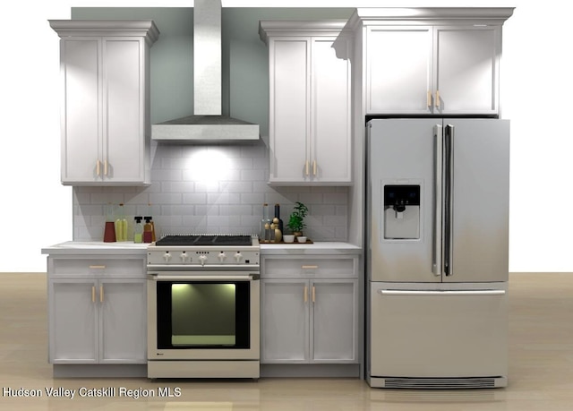 kitchen with backsplash, fridge with ice dispenser, high end range, and wall chimney exhaust hood