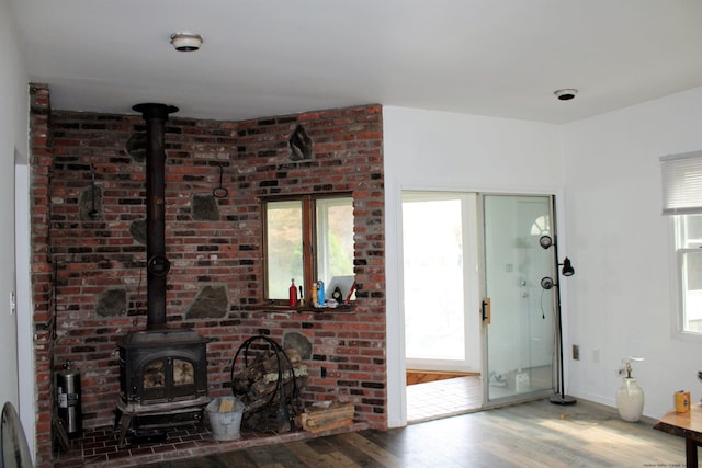 living room with a wood stove and hardwood / wood-style flooring