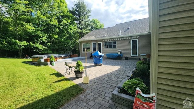 view of patio featuring a covered hot tub