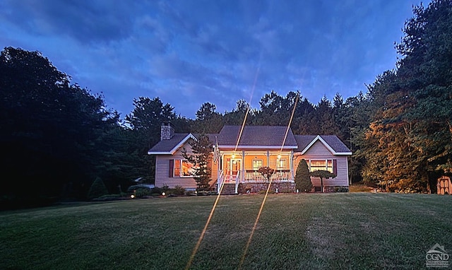view of front of home with a front yard and a chimney