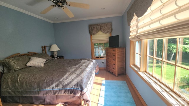 bedroom with wood finished floors, crown molding, and a ceiling fan