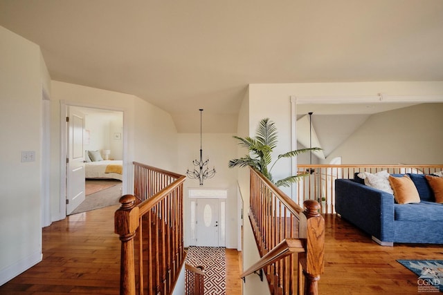 27 Gallagher Ln, Pleasant Valley, NY 12569 - corridor featuring an upstairs landing, hardwood / wood-style flooring, lofted ceiling, a chandelier, and baseboards