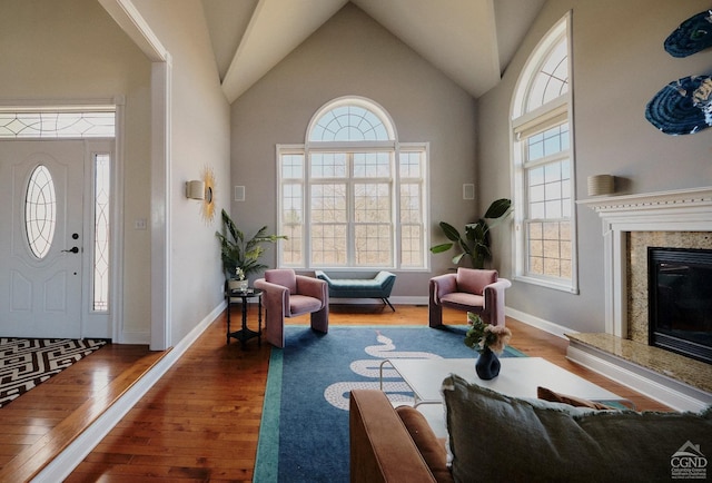 27 Gallagher Ln, Pleasant Valley, NY 12569 - foyer featuring wood finished floors, high vaulted ceiling, a high end fireplace, and baseboards