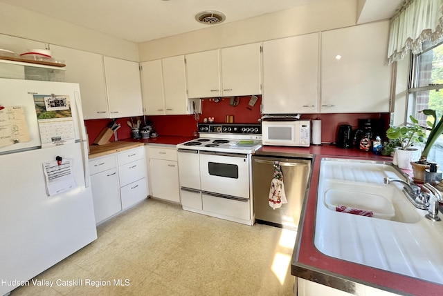 24 Linden Ave, Red Hook, NY 12571 - kitchen featuring white appliances, light floors, white cabinets, and dark countertops
