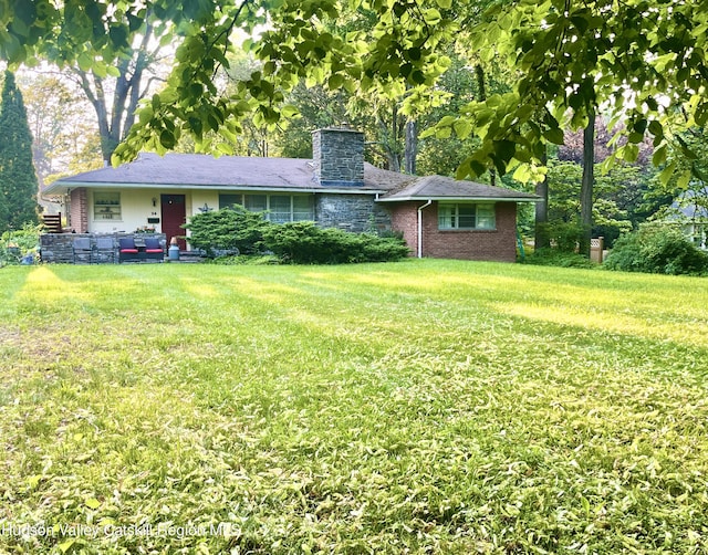 24 Linden Ave, Red Hook, NY 12571 - ranch-style house with a front lawn, a chimney, and brick siding