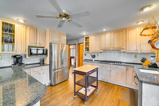 108 Botti Dr, Hunter, NY 12442 - kitchen featuring stainless steel appliances, a sink, light brown cabinets, ceiling fan, and backsplash