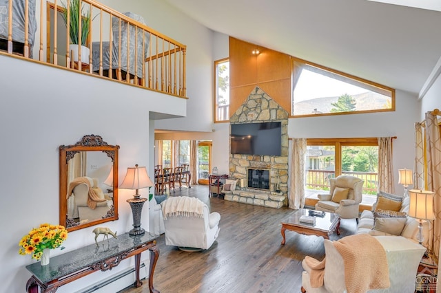 108 Botti Dr, Hunter, NY 12442 - living area with high vaulted ceiling, plenty of natural light, wood finished floors, a stone fireplace, and baseboard heating