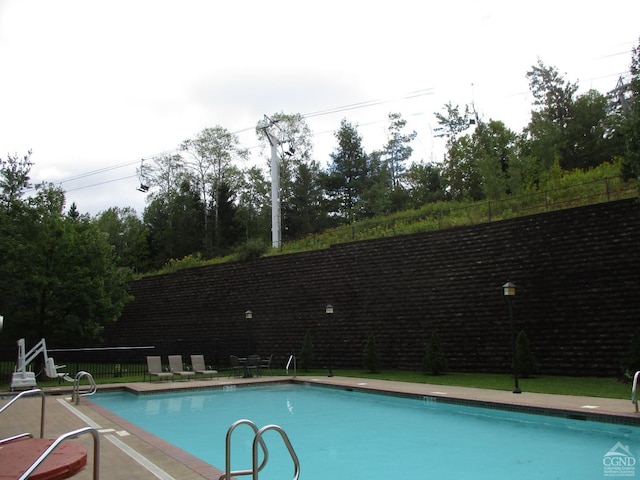 64 Liftside Dr Unit E-5, Hunter, NY 12442 - view of swimming pool featuring fence and view of wooded area