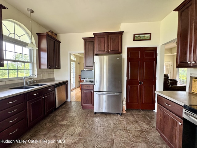 2914 Sleepy Hollow Rd, Athens, NY 12015 - kitchen featuring stainless steel appliances, decorative backsplash, pendant lighting, dark stone finish floors, and light countertops