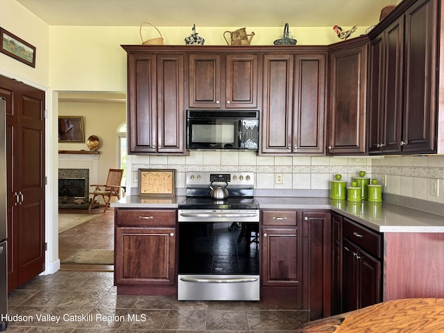 2914 Sleepy Hollow Rd, Athens, NY 12015 - kitchen featuring black microwave, stainless steel range with electric stovetop, light countertops, backsplash, and a fireplace