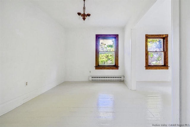 spare room with plenty of natural light and baseboard heating