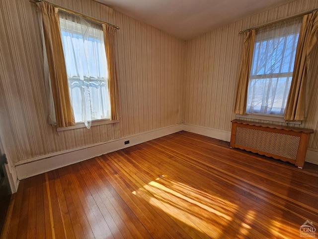 2322 US Route 9, Hudson, NY 12534 - unfurnished room with radiator heating unit, wood-type flooring, and baseboards