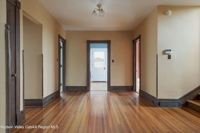 entrance foyer with dark hardwood / wood-style floors and an inviting chandelier