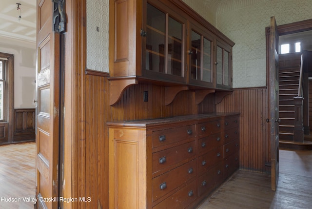 kitchen with hardwood / wood-style flooring and wood walls