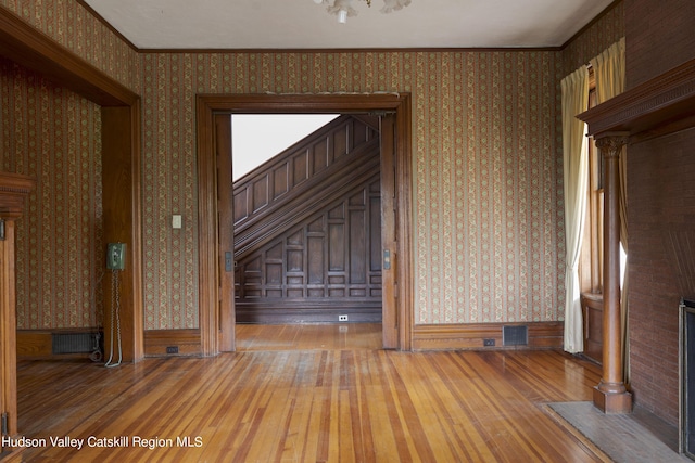 interior space featuring hardwood / wood-style floors and ornamental molding