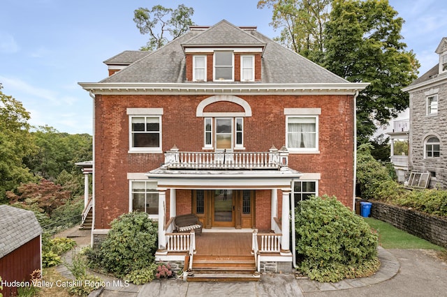 view of front of property with a porch and a balcony