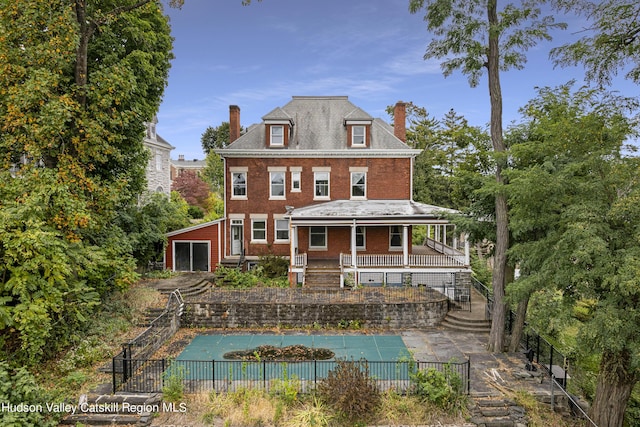 back of house featuring a covered pool