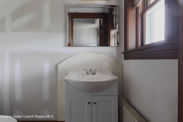 bathroom with radiator heating unit and vanity