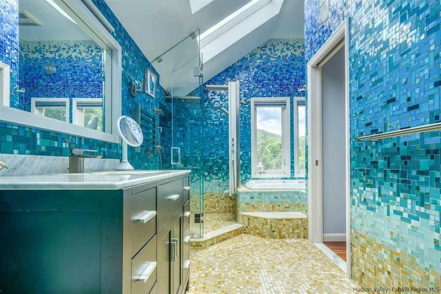 bathroom featuring vaulted ceiling, a stall shower, a bath, and a wealth of natural light