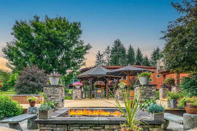 exterior space featuring a gazebo and a fire pit